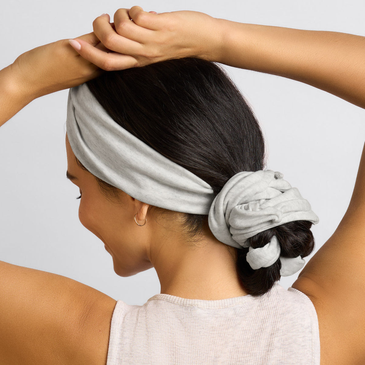 Gray curling headband worn with gathered hair