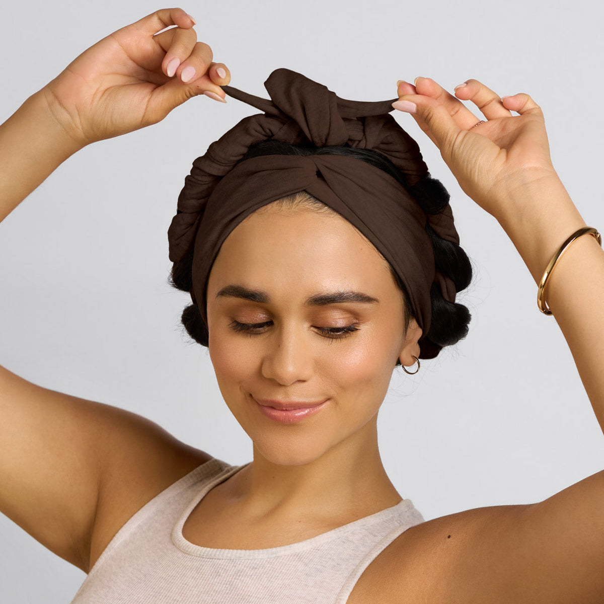 Brown curling headband worn with wrapped hair